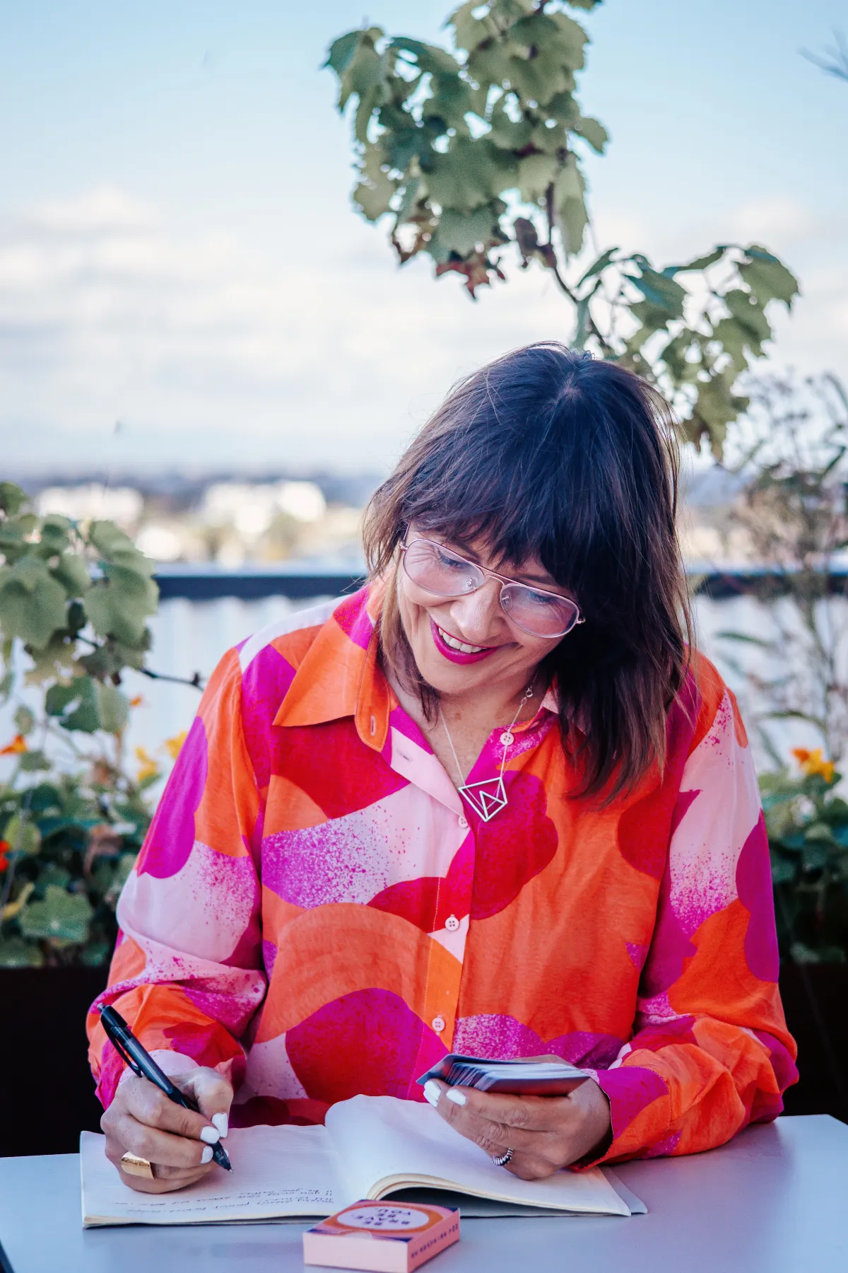 Karla Gwendoline life coach writing in notebook during values-based personal harmony coaching work