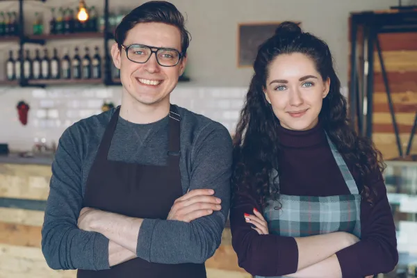 business owners smiling at camera with increased revenue infrastructure