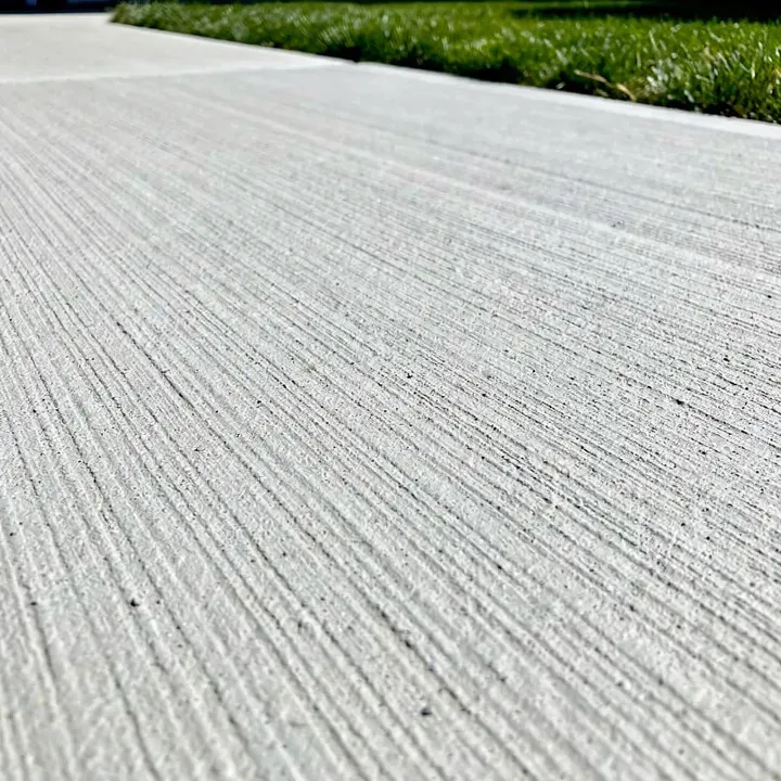 Close-up of a freshly finished concrete patio surface in Beloit, Wisconsin on a sunny day.