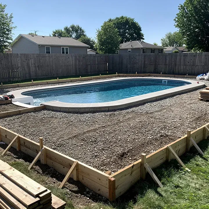 Pool deck construction project in progress with concrete forms around a backyard pool in Beloit, Wisconsin.