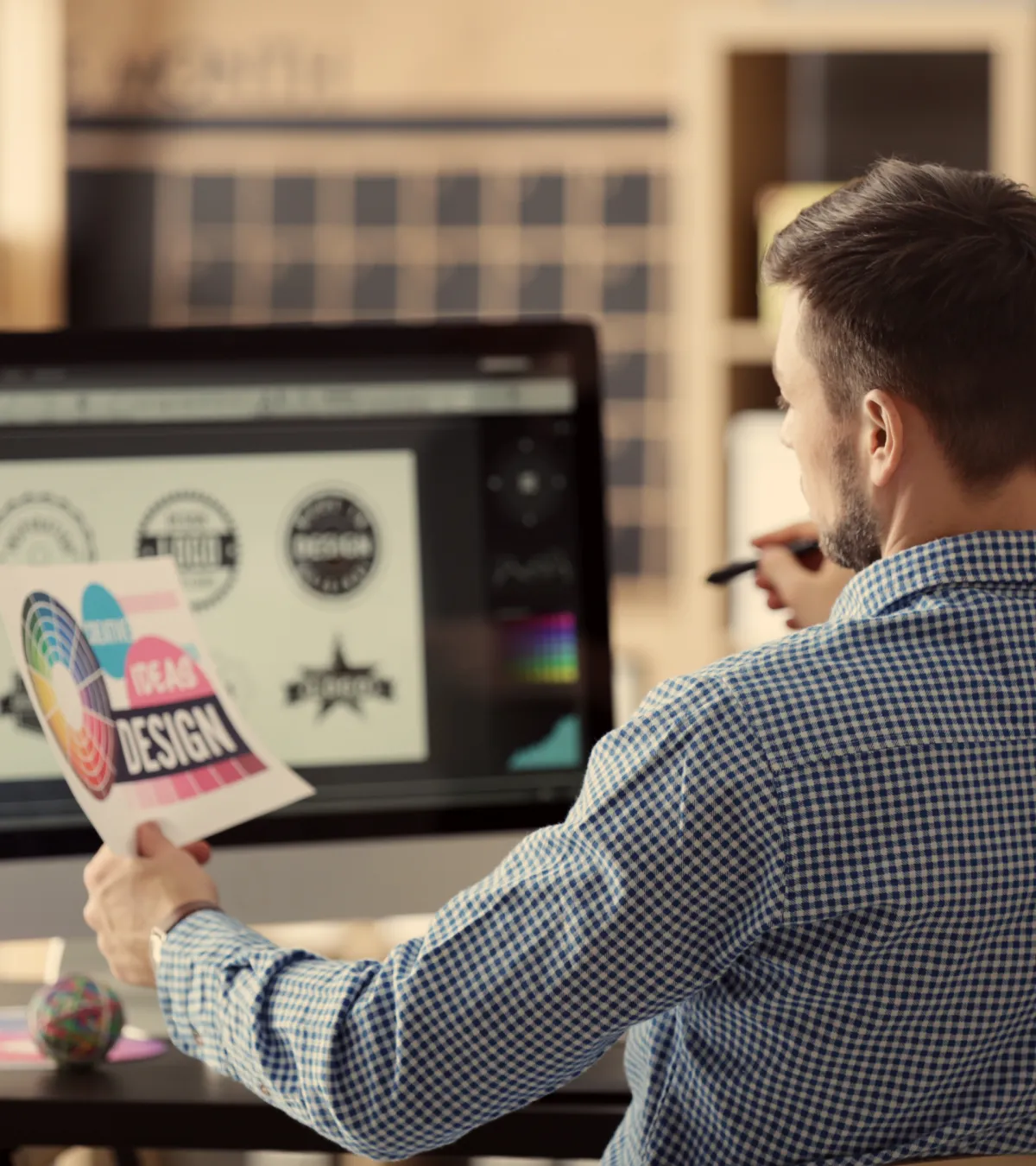 Small business owner holding brand style guide