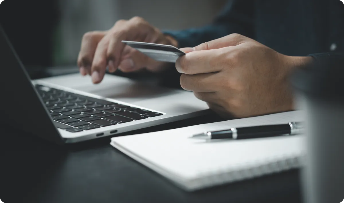 Person making an online booking payment on a laptop for a scheduled appointment