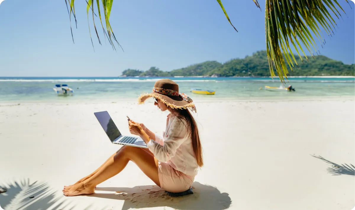 Woman on a beach taking a 1:1 video strategy call for business planning