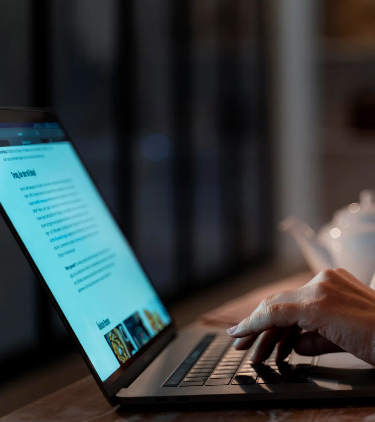 Person typing on a laptop, creating or editing a blog post, with a focus on content writing and digital workspace