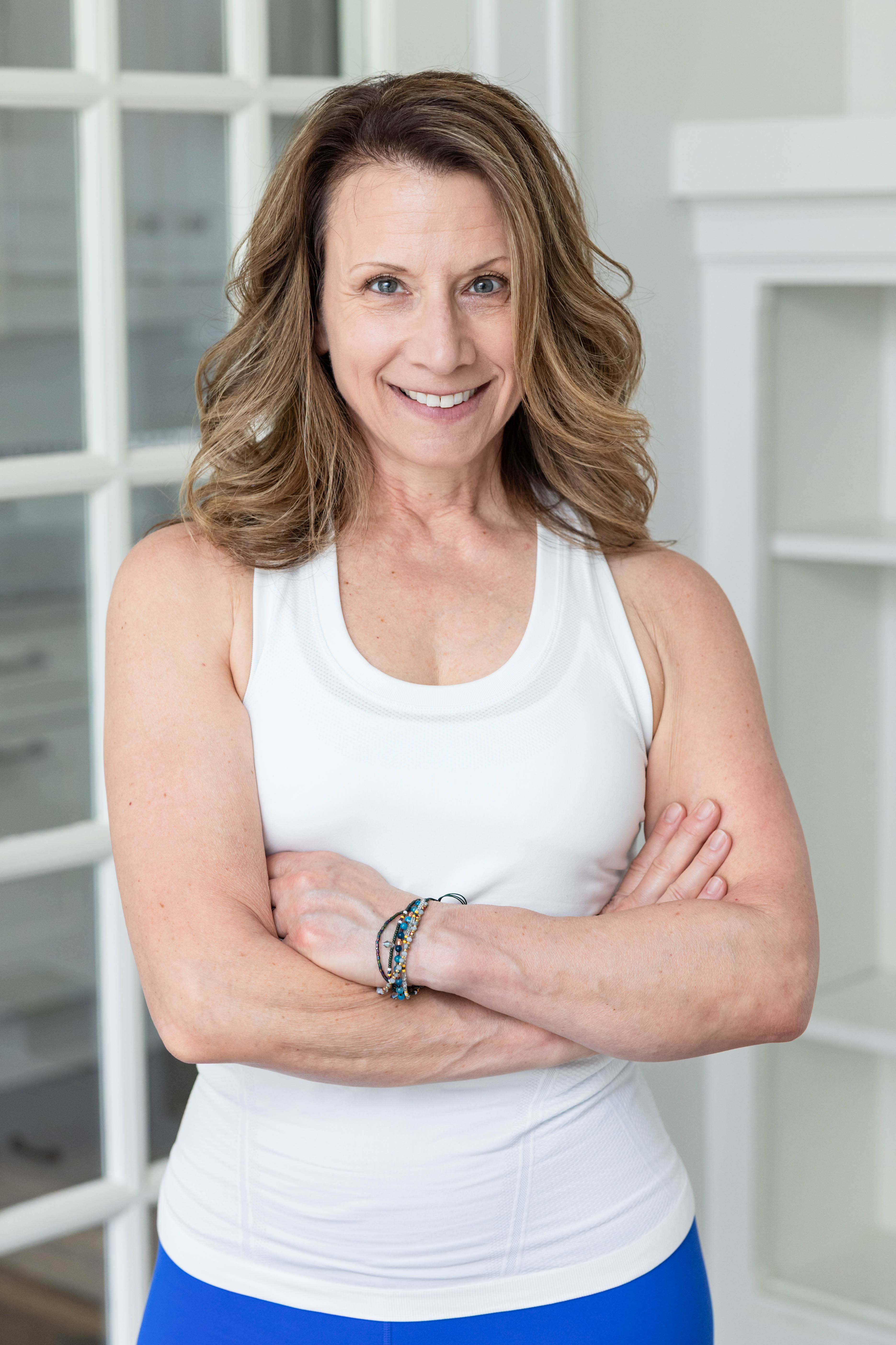 Maria Rigo seated at the top of the table smiling with some vegetables on the side