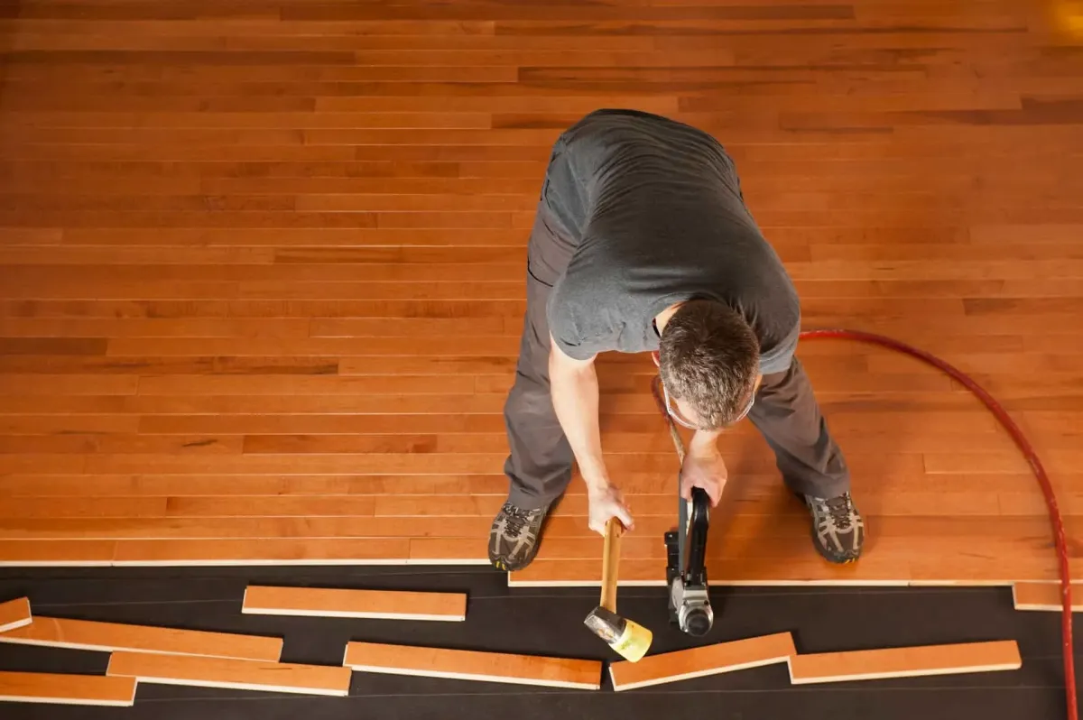 rofing expert installs new roof tiles on the top of resi