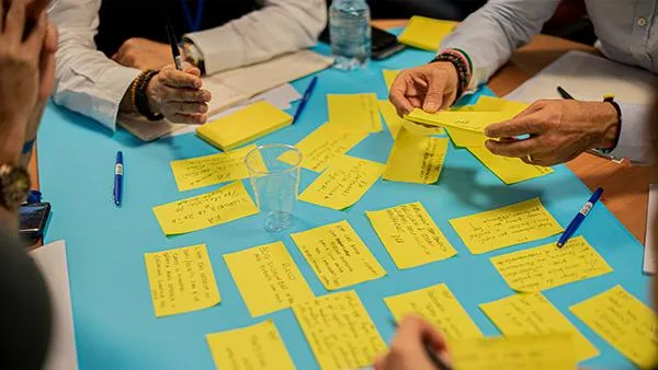 silhouette of man and woman facing each other during golden hour
