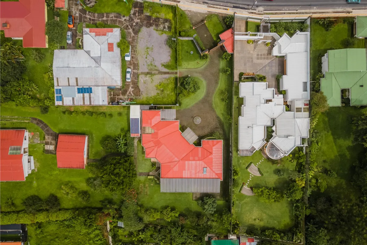 brown and white concrete house beside river during daytime