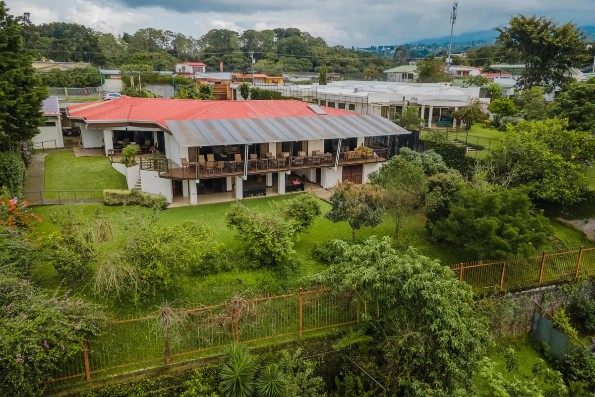 brown and white concrete house beside river during daytime