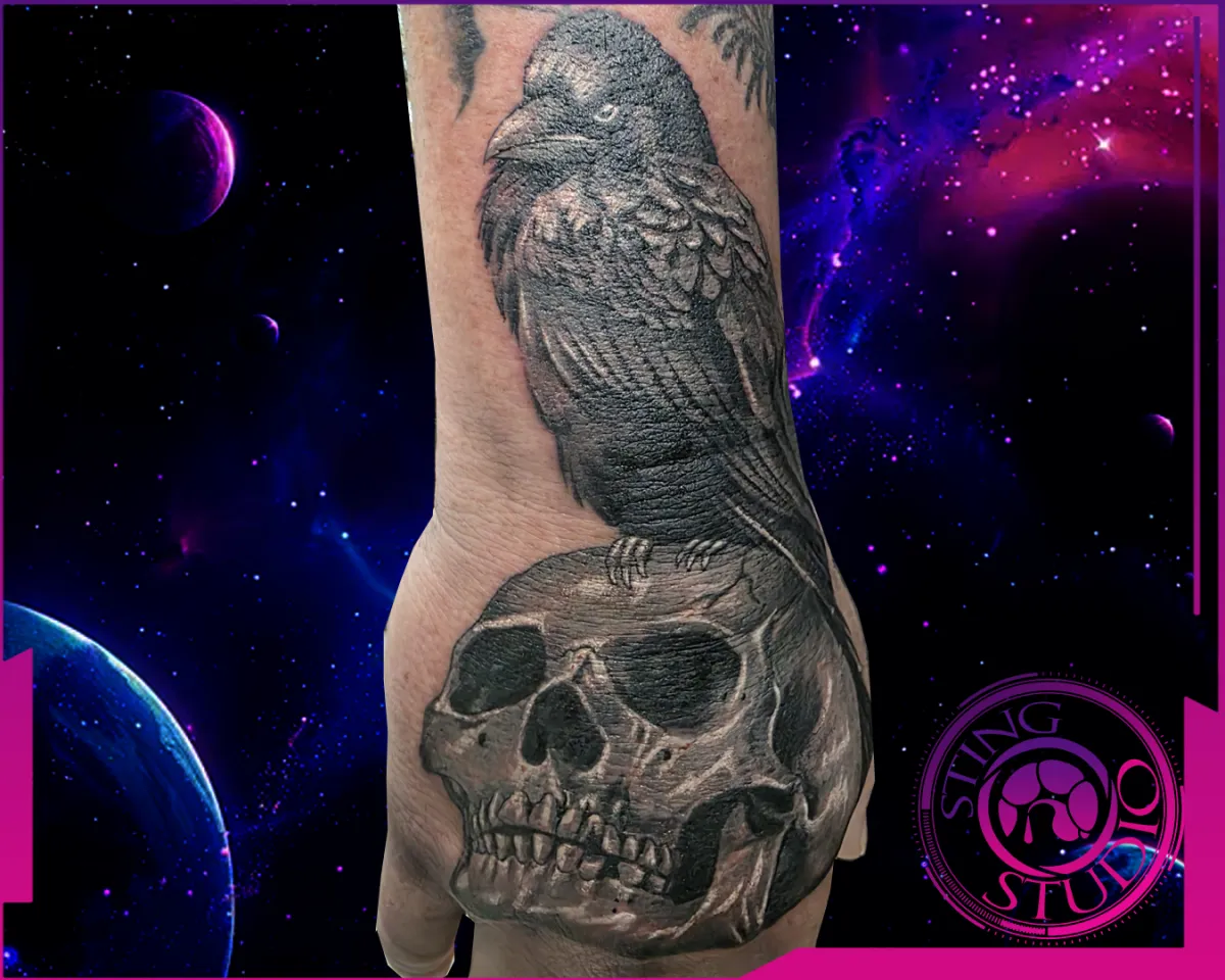 crow skull hand tattoo