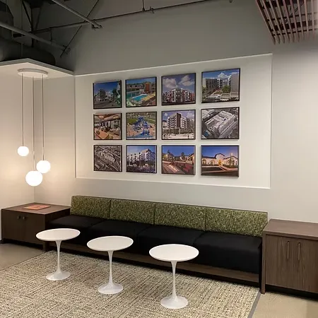 Commercial artwork installation project featuring coordinated framed artwork display in a modern office environment