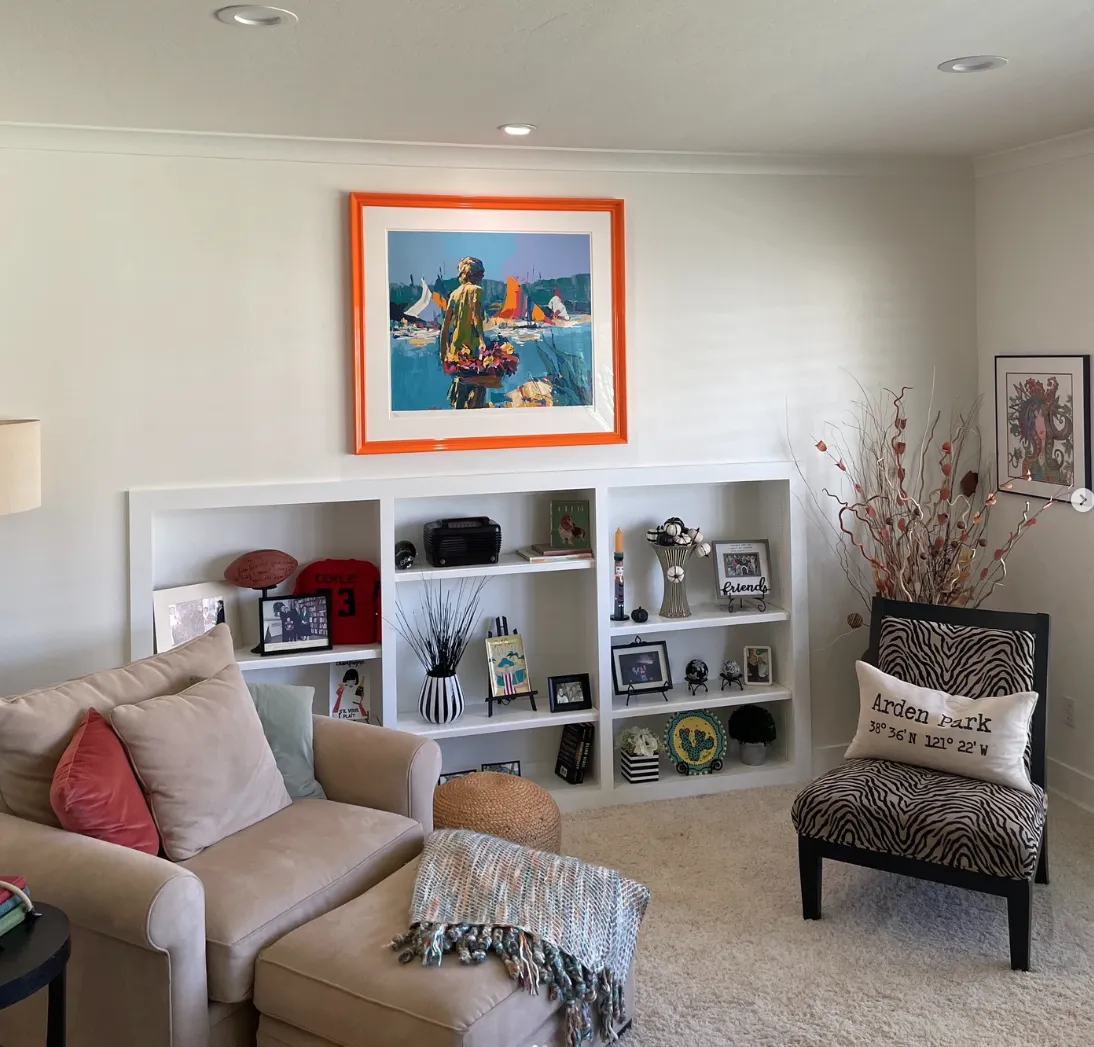 Residential artwork installation featuring custom framed artwork placement within a finished living space