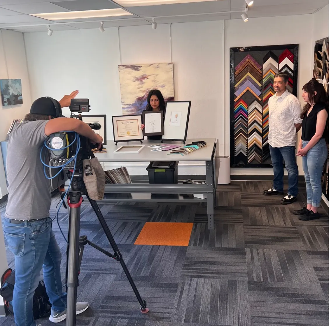 Conan Ridzik discussing artwork and framing projects in a gallery setting, showcasing professional artwork handling and installation experience.