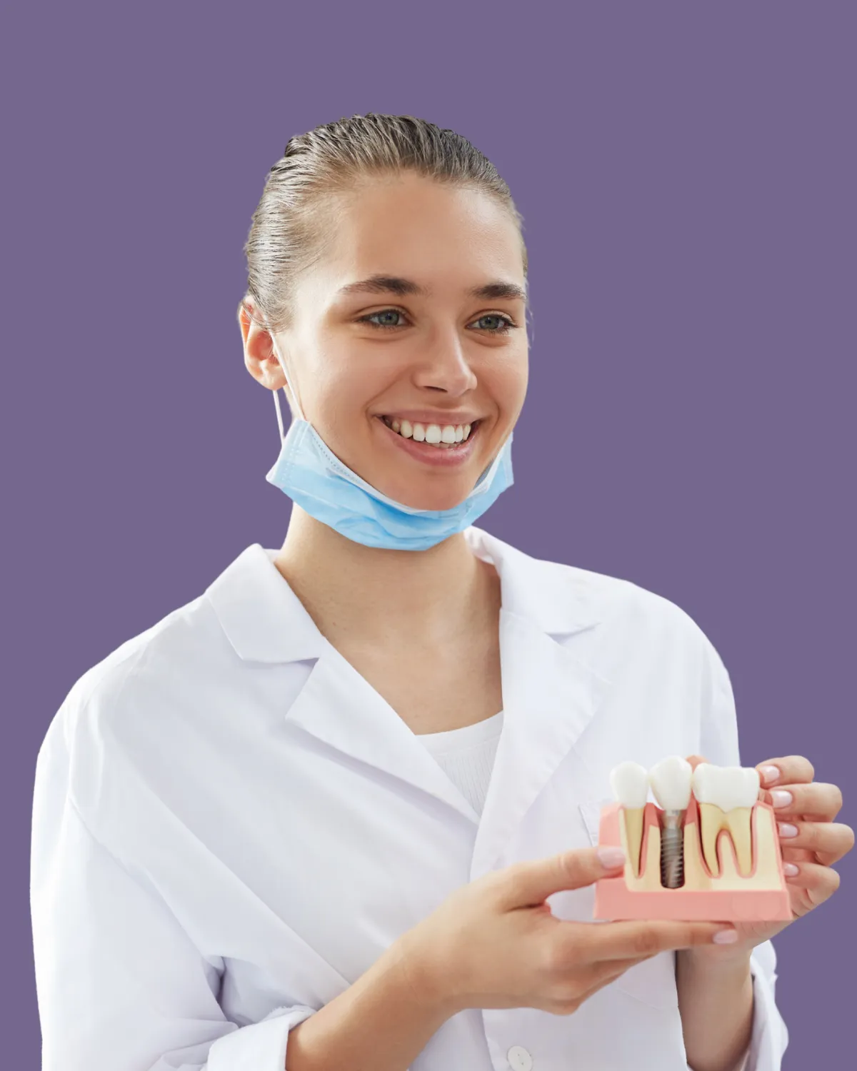 Dentist showing dental implant model for tooth replacement dental surgery.