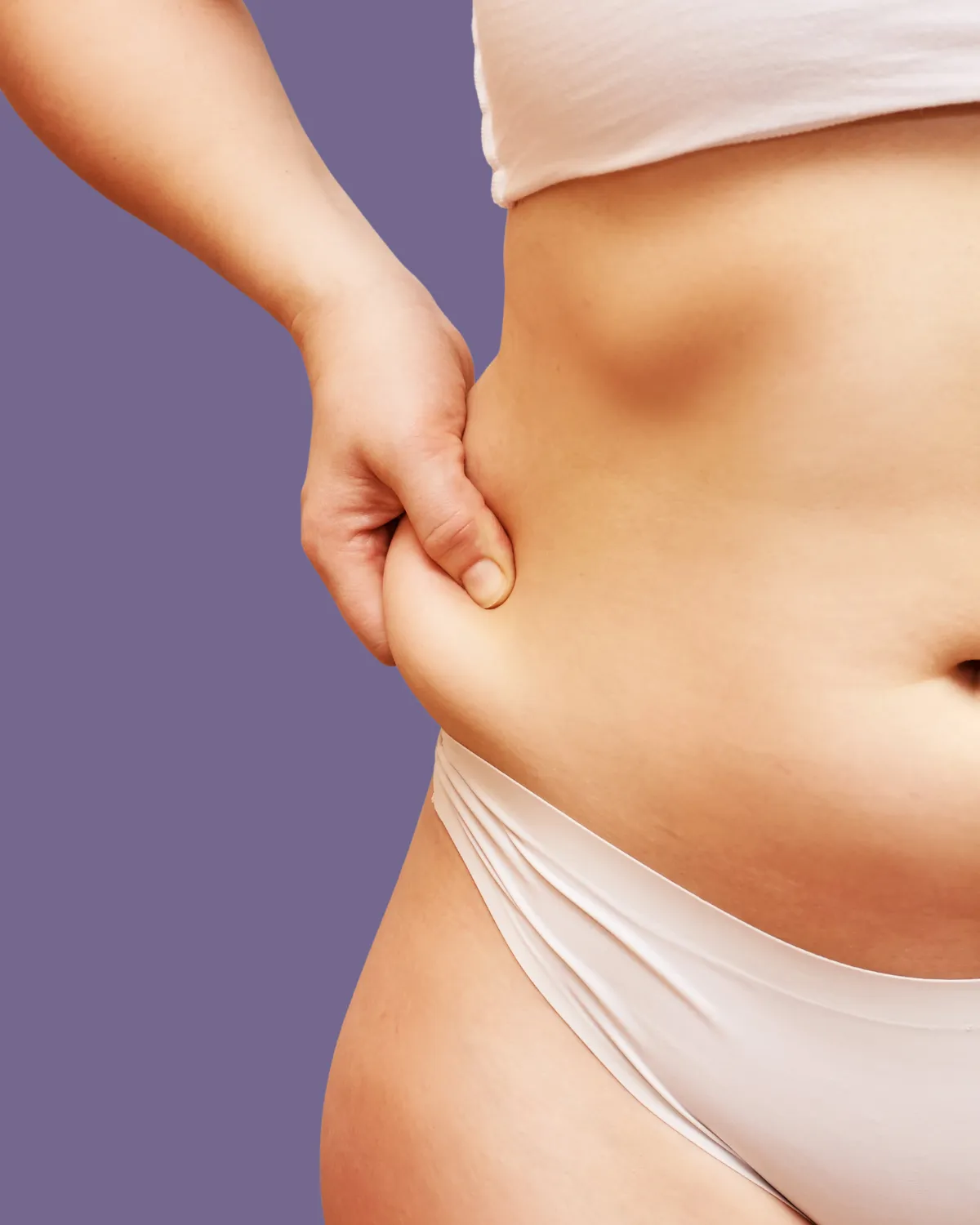 Close-up of midsection showing loose skin before post-bariatric tummy tuck.