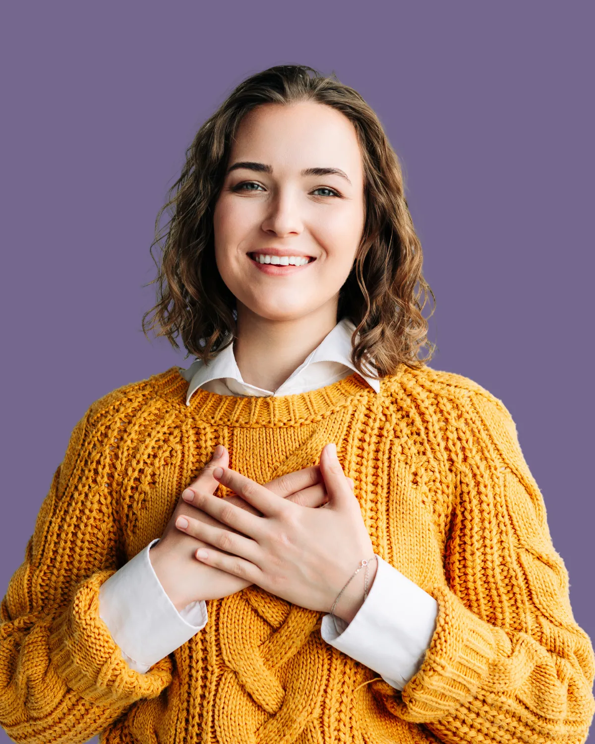 Woman holding her chest, symbolizing commitment.