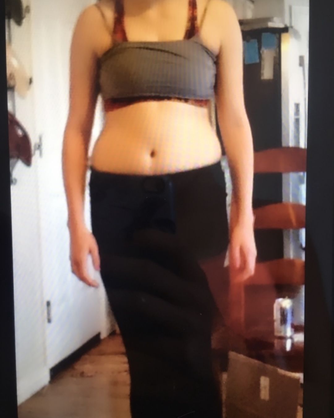 woman in black long sleeve shirt holding white ceramic mug