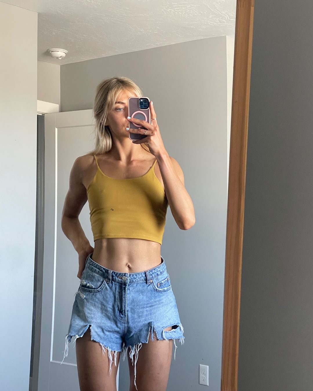 woman in black long sleeve shirt holding white ceramic mug