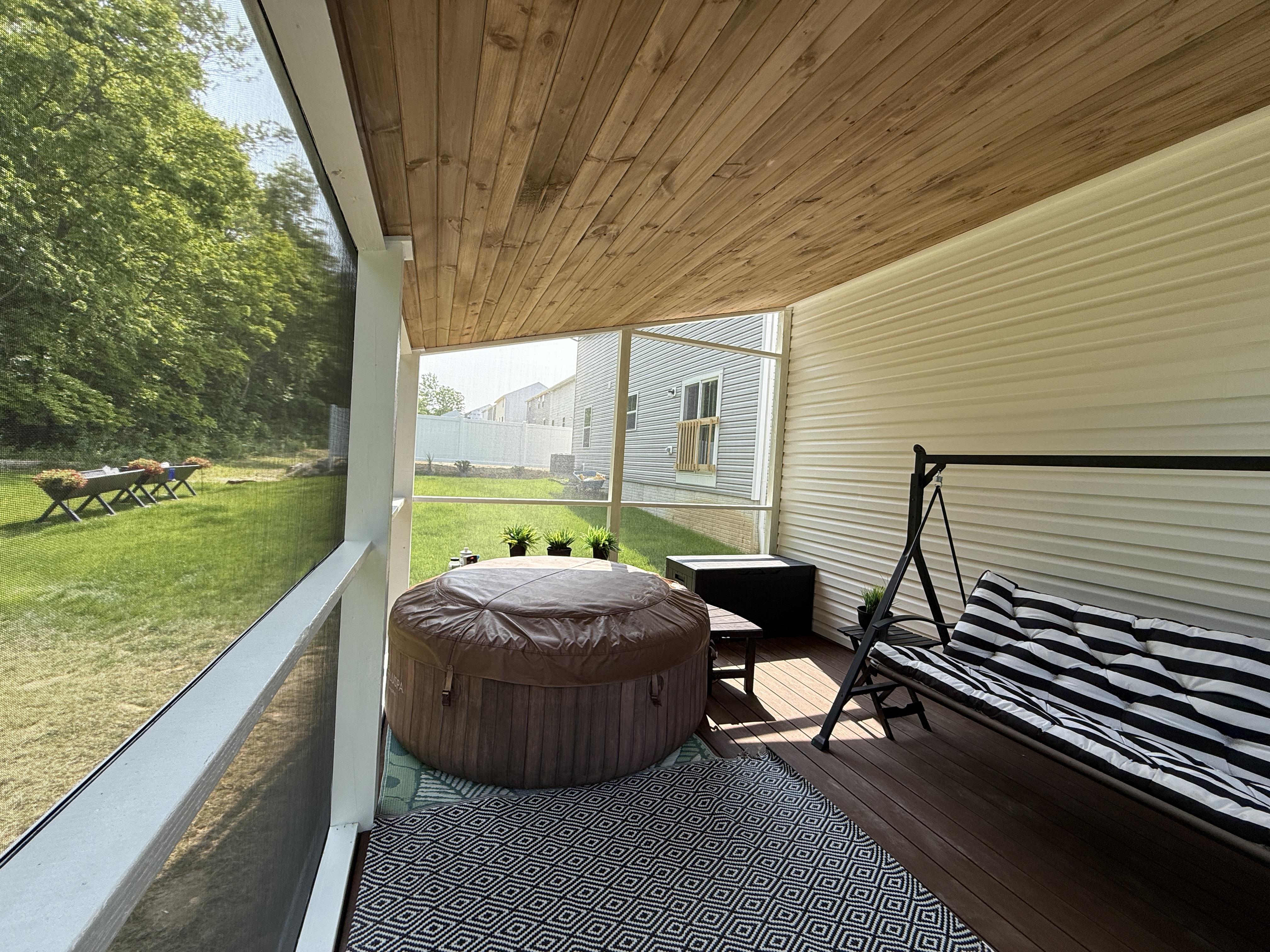 Multi-level composite deck with stairs and railing built by professional deck contractors