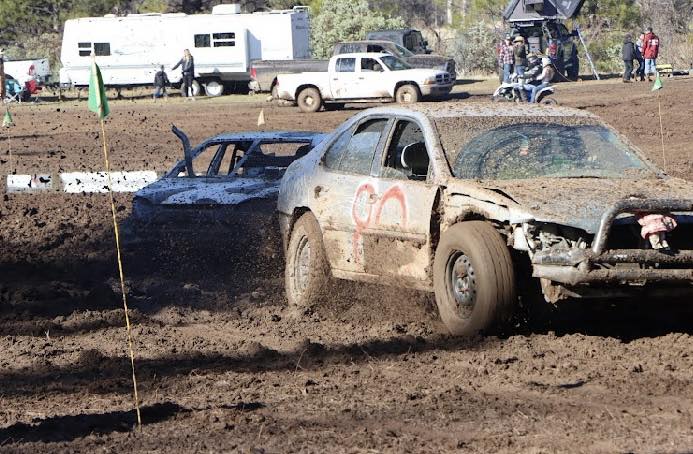 Lineup of lifted trucks waiting to run the mud pit