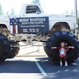 Kids next to a mud truck