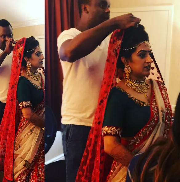 man sitting near gray steel roller shutters during daytime
