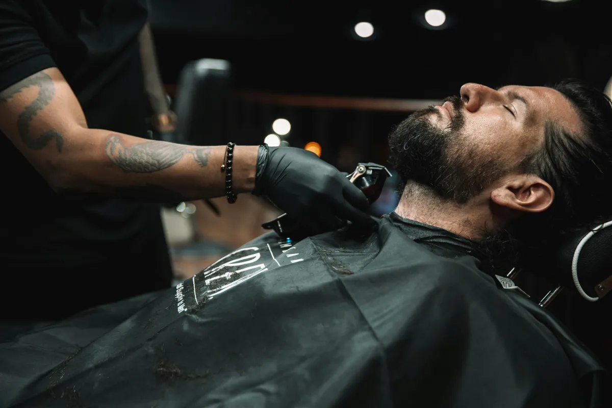 A man getting his hair cut in a barber shop