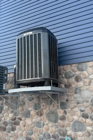 Building facade with many windows under blue sky.