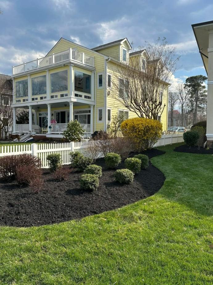 Well-maintained side yard in Appleton with small green bushes and a clean edge