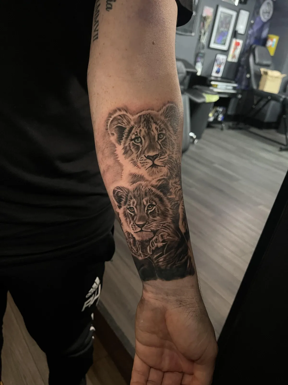 person in blue denim shorts and white nike sneakers standing on gray concrete floor