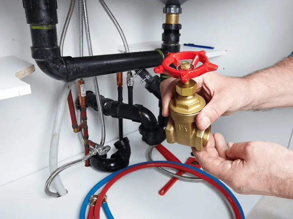 Modern emergency plumbing setup in Breckenridge, CO with copper, stainless steel pipes, valves, and fittings in a clean, organized workshop.