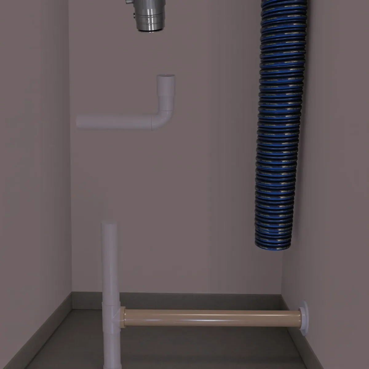 Emergency plumber fixing a leak under a sink in a modern kitchen in Eagle, CO.