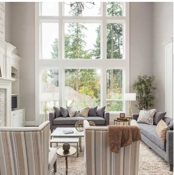 Interior living room with tall vinyl picture windows recently installed at an Oakville home by Fasada.