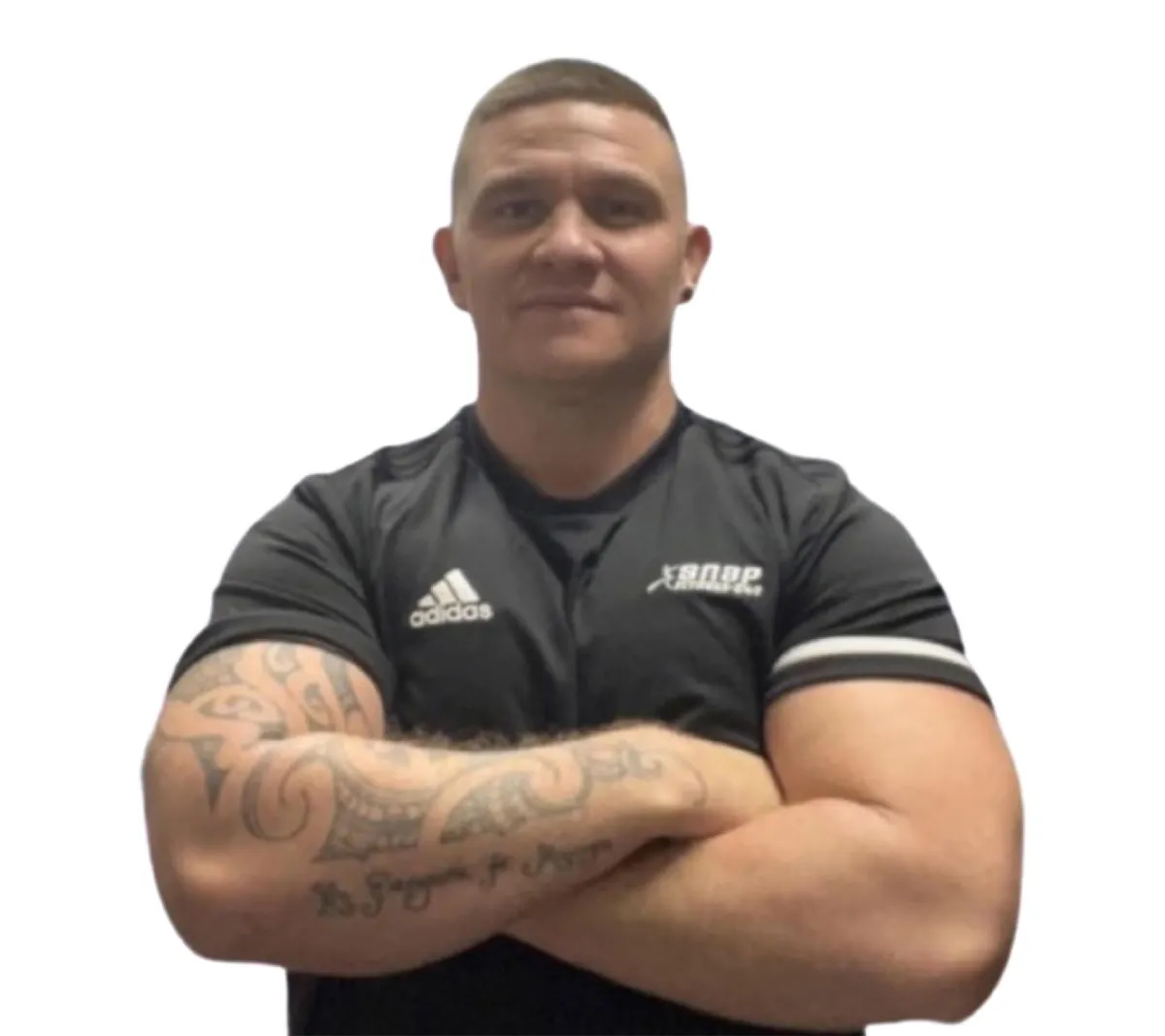 A close-up portrait of Coach Jobe, smiling warmly, wearing a branded fitness shirt, with a blurred outdoor park in the background. The image highlights his approachable demeanor and professional expertise, inviting trust from potential subscribers.