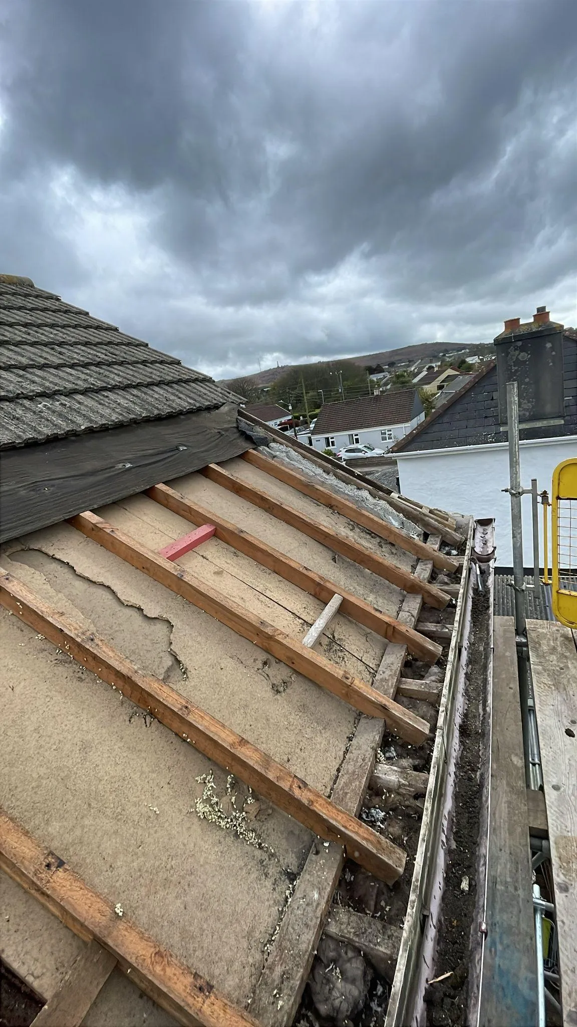 A roof with a birdhouse on top of it