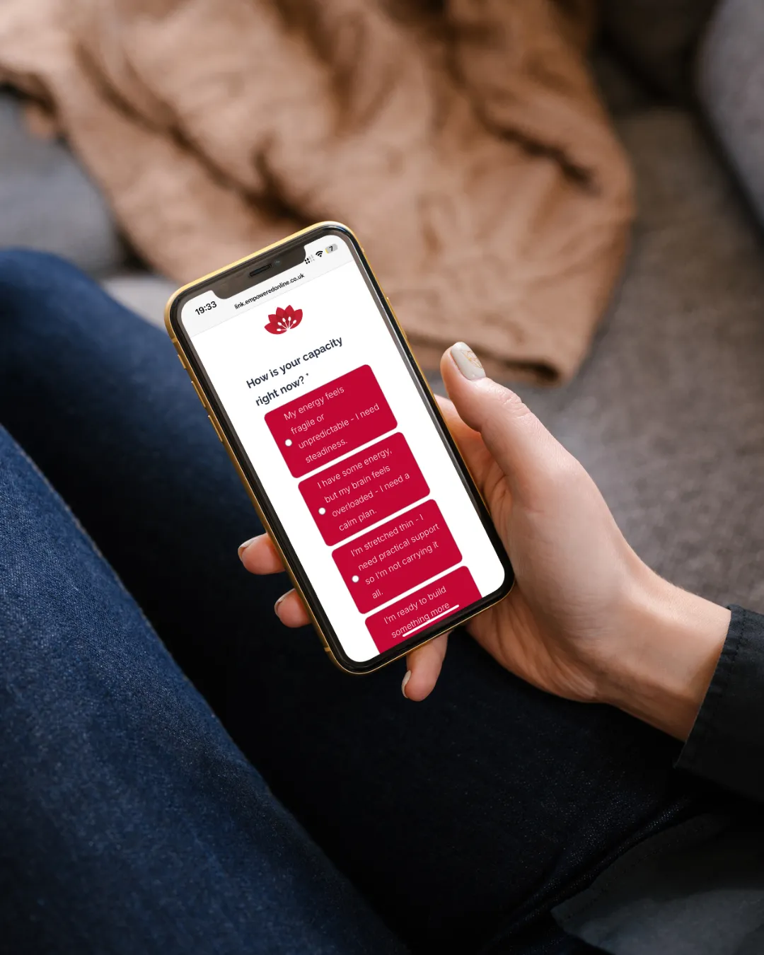 Somebody holding a phone displaying an Empowered Online quiz.