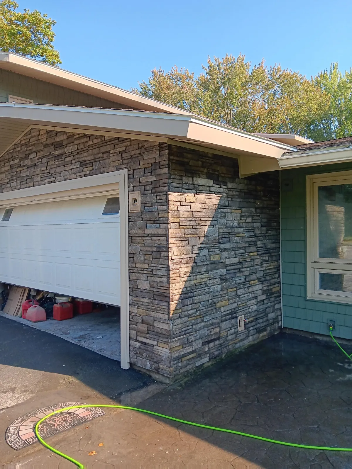 Newly installed replacement windows and garage door by Rebuilding 2nd Chances Construction, enhancing curb appeal and energy efficiency for homes in Herkimer, NY