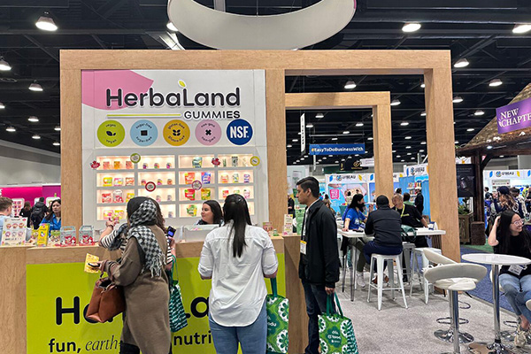 Convention hall with branded trade show booths and networking attendees
