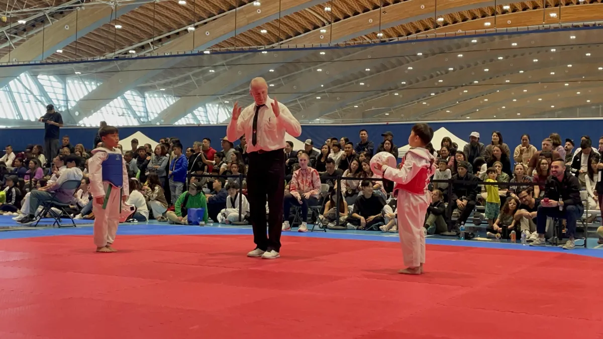 Two taekwondo students bowing before a match at a tournament at Metro TKD Studios in Burnaby