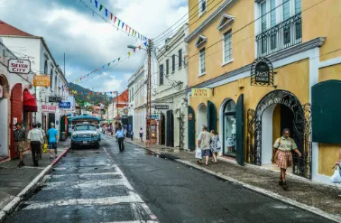 Busy street scene with cars, motorcycles, and pedestrians.