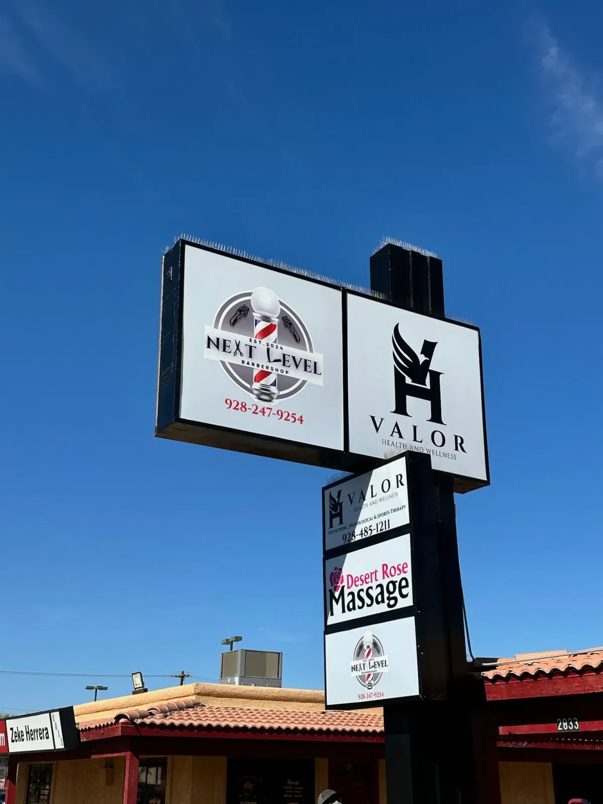 A large sign that showcases multiple businesses