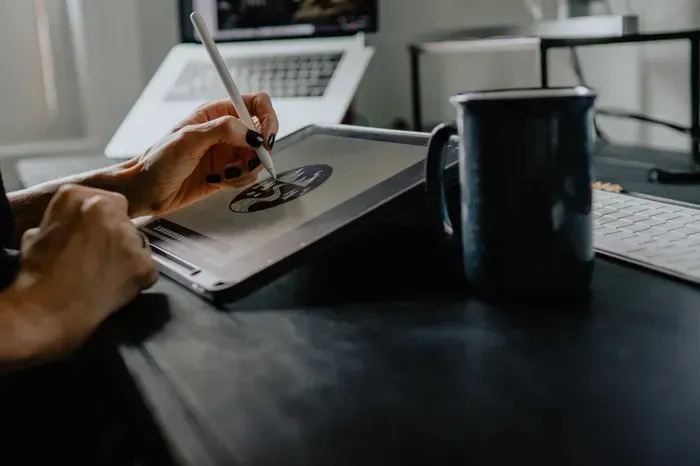 Image of an artist drawing on a tablet