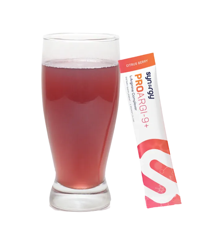 Glass of mixed ProArgi-9+ drink with a stick packet