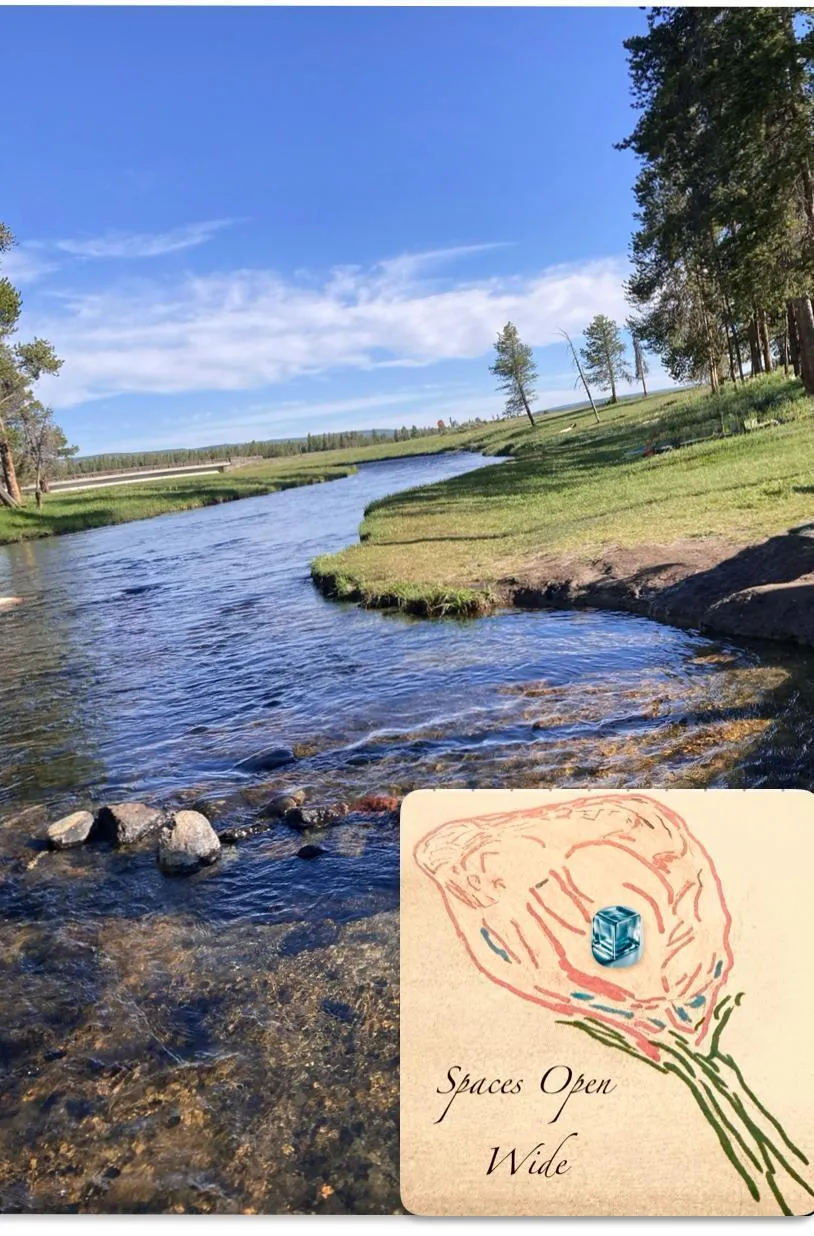 body of water near mountain during daytime