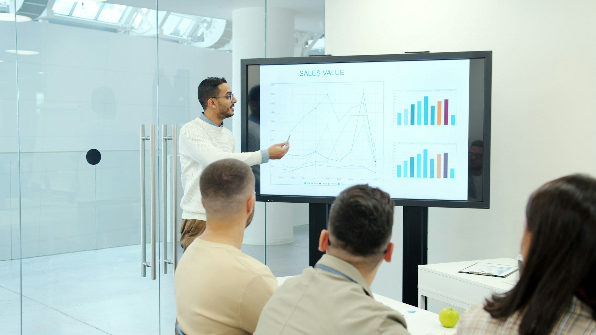 Man presenting charts to board