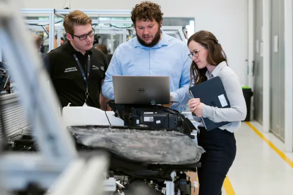 Team of engineers collaborating on a project in a modern industrial facility.