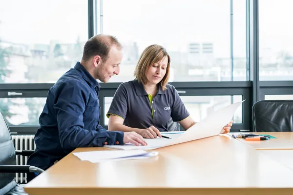 People reviewing documents at a desk