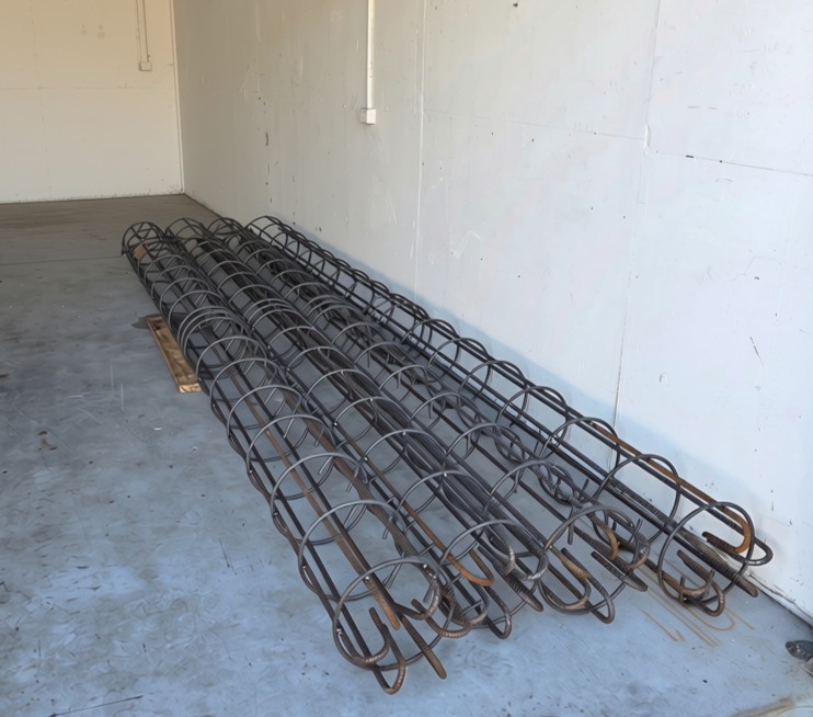 Prefabricated steel reinforcing cages built to specification, ready for concrete pour