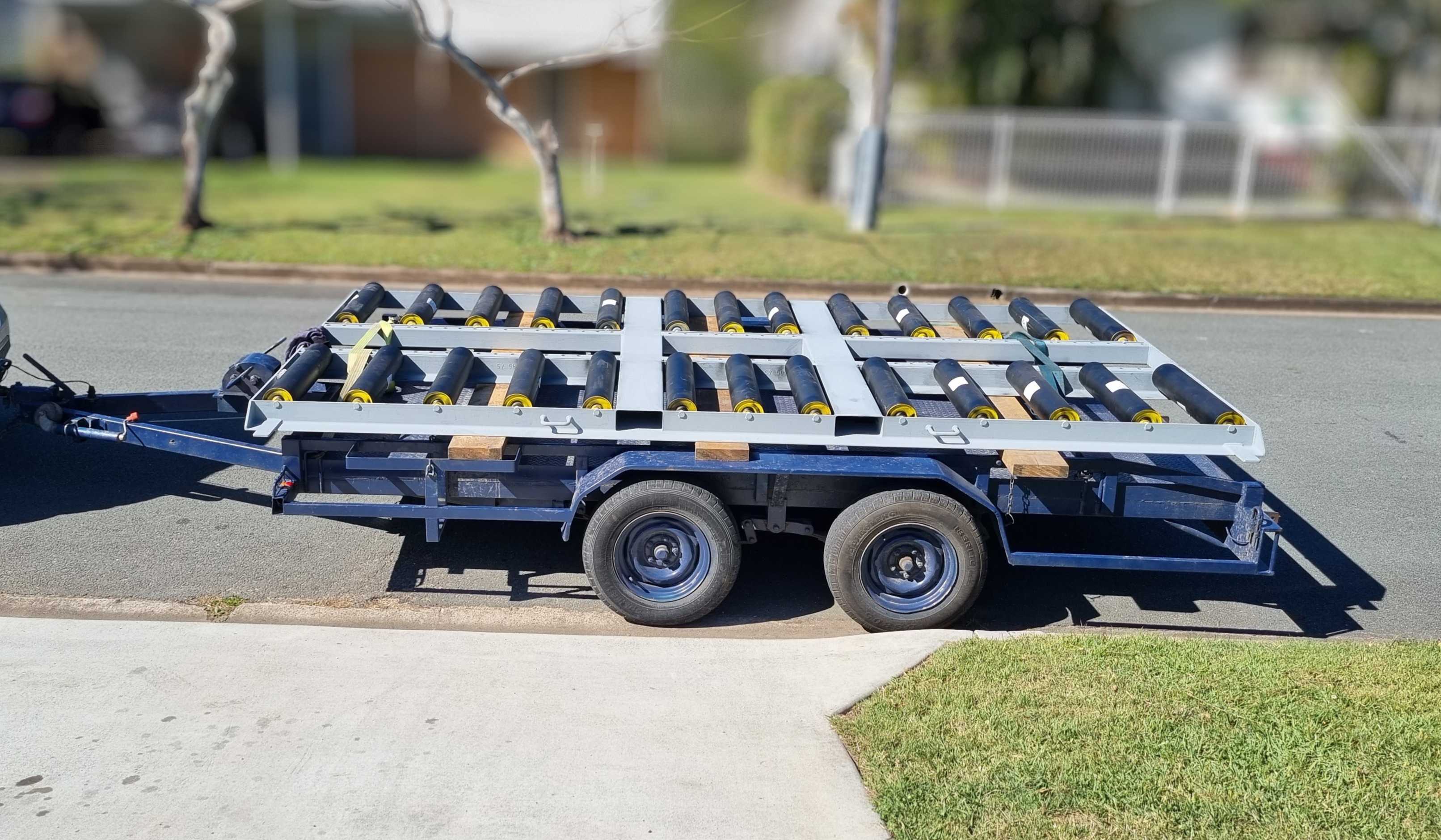 Fabricated steel frame with rubber-mounted supports loaded on a tandem trailer ready for site delivery