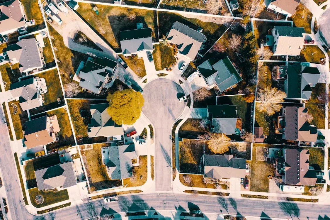 Aerial view of a suburban neighborhood with houses and a cul-de-sac.